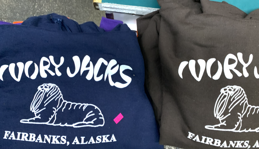 Folded pair of Ivory Jacks Hoodies, blue and coffee brown. Both feature the Ivory Jacks name and walrus logo.